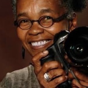 Portrait of Sharon Farmer holding camera